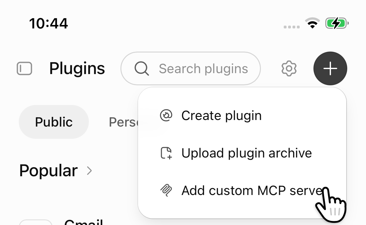 The Plugins page on chatgpt.com with the + menu open and a hand tapping Add custom MCP server.